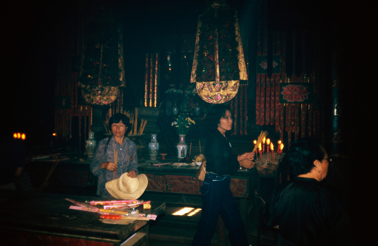 Woman worshiping in Kun Iam Tong Temple [Kwun Yum Temple] in Macau (Macao)