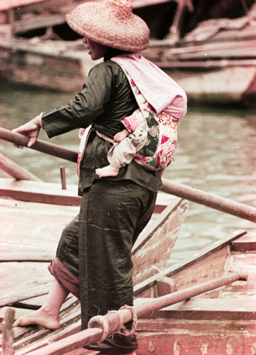 Woman on boat with a baby at the back